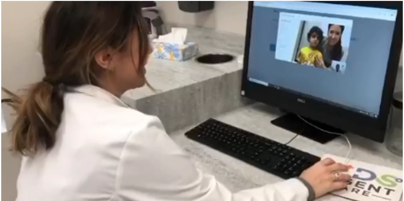 Pediatrician in PPE performing a gentle COVID-19 nasal swab for a child